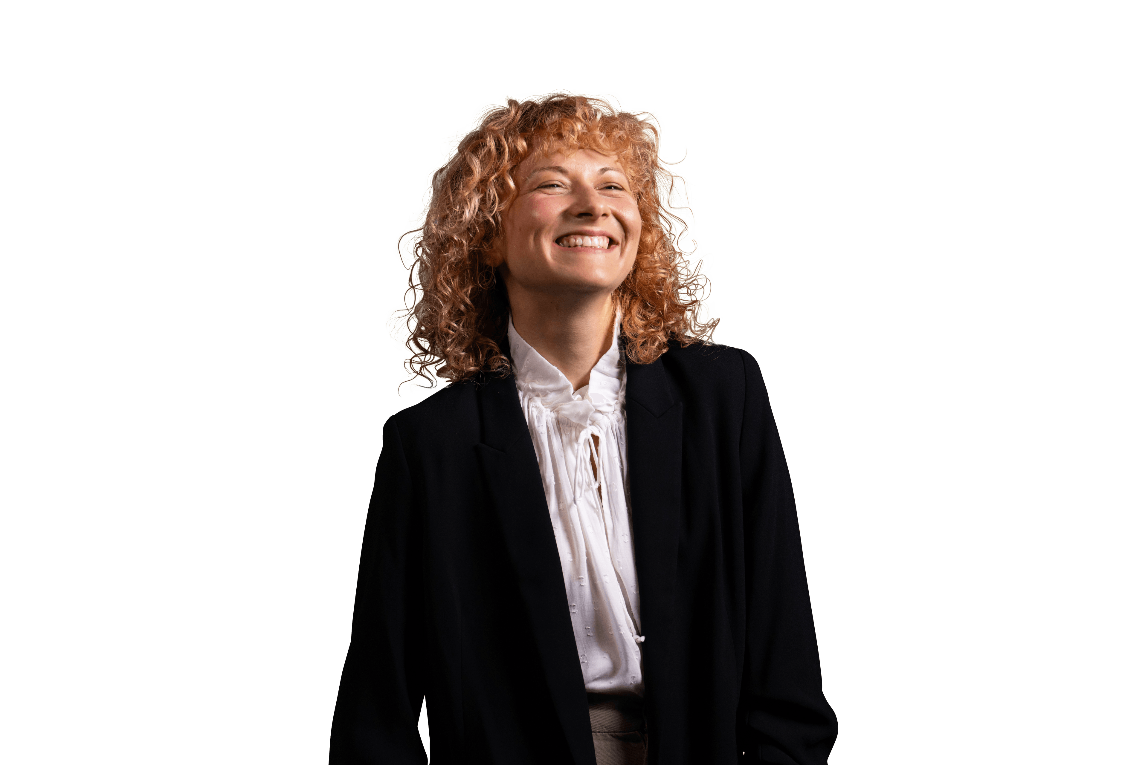 a woman with curly hair is smiling and wearing a black jacket